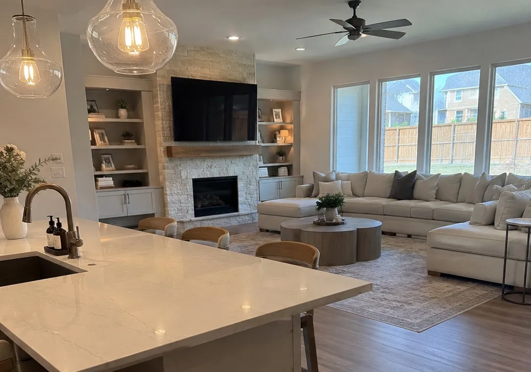 Spotless open-concept kitchen island and living room in a Frisco, TX home after professional house cleaning